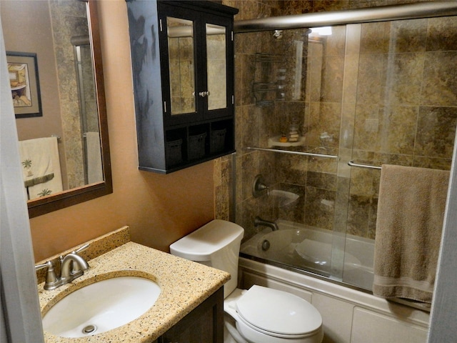 bathroom featuring shower / bath combination with glass door, vanity, and toilet