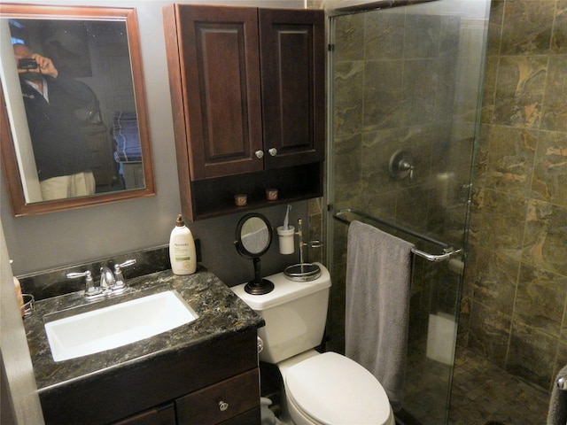 full bath with toilet, a stall shower, and vanity