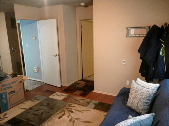 bedroom with baseboards and wood finished floors