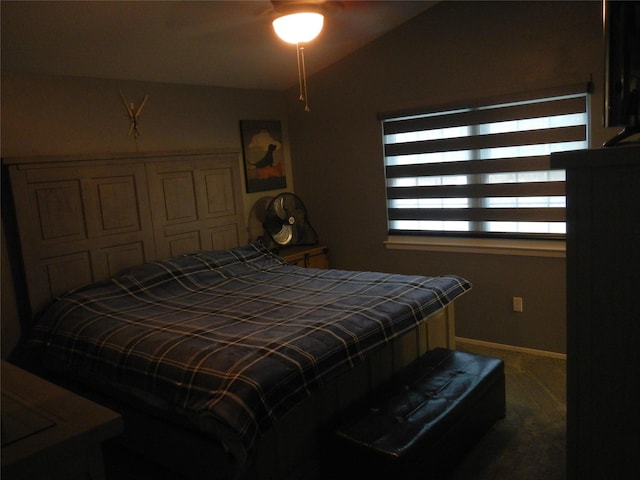 carpeted bedroom featuring lofted ceiling and baseboards