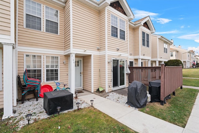 rear view of property featuring a yard