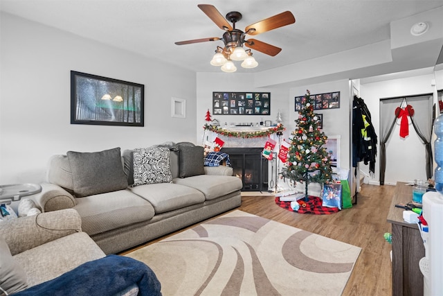 living room with ceiling fan and light wood-type flooring