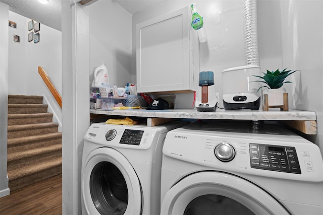 washroom with washer and clothes dryer, dark hardwood / wood-style flooring, cabinets, and a textured ceiling