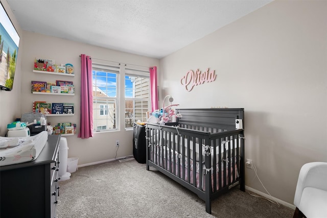 bedroom with a crib and carpet floors