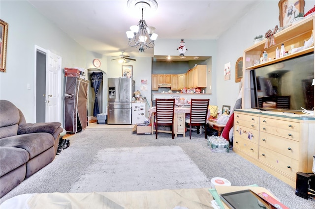 carpeted living room with ceiling fan with notable chandelier