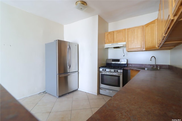 kitchen with sink, light tile patterned floors, stainless steel appliances, and light brown cabinets