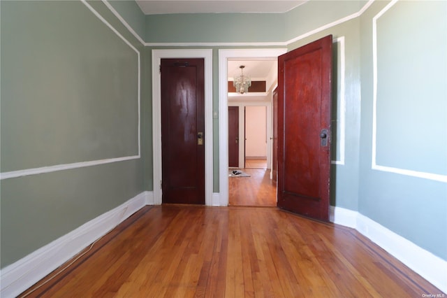 interior space with a chandelier and hardwood / wood-style flooring