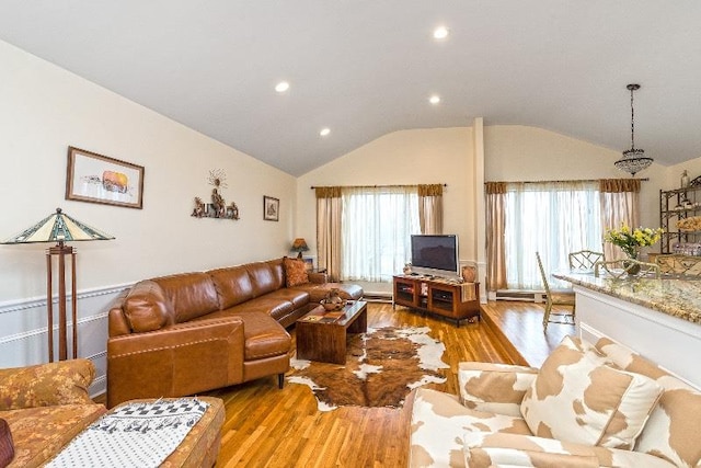 living room featuring light wood-type flooring and vaulted ceiling