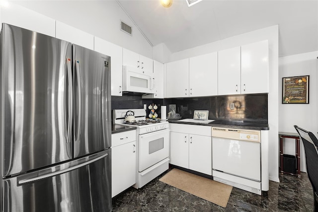 kitchen featuring white cabinetry, sink, tasteful backsplash, vaulted ceiling, and white appliances