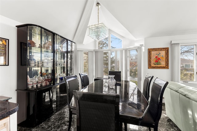 dining space with vaulted ceiling and an inviting chandelier