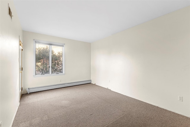 empty room featuring carpet floors and a baseboard heating unit