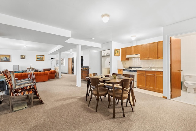 dining area featuring light carpet