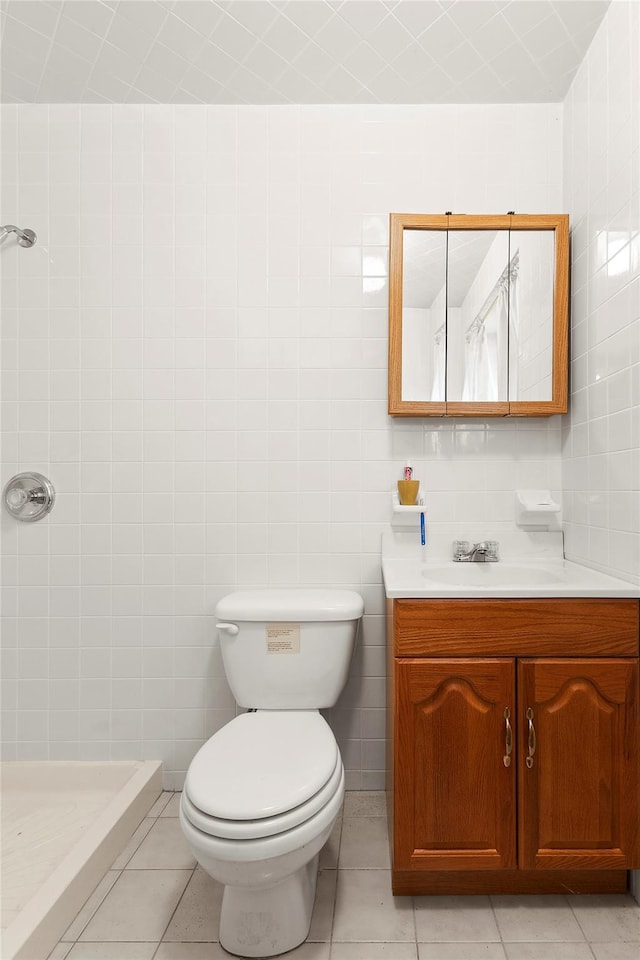 bathroom with a shower, tile patterned flooring, vanity, and toilet