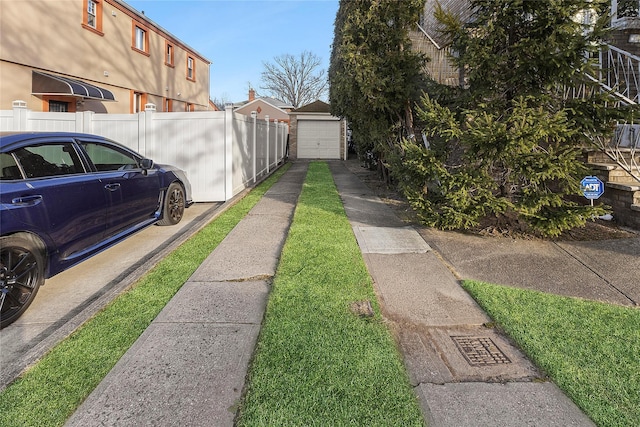 view of yard featuring an outbuilding and a garage