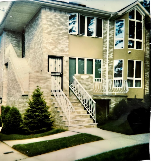 exterior space with brick siding and stucco siding