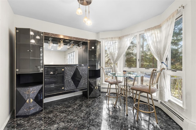 interior space with marble finish floor and a baseboard heating unit