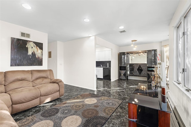 living area with a baseboard heating unit, marble finish floor, visible vents, and recessed lighting