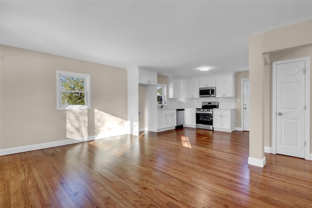 unfurnished living room featuring light hardwood / wood-style floors