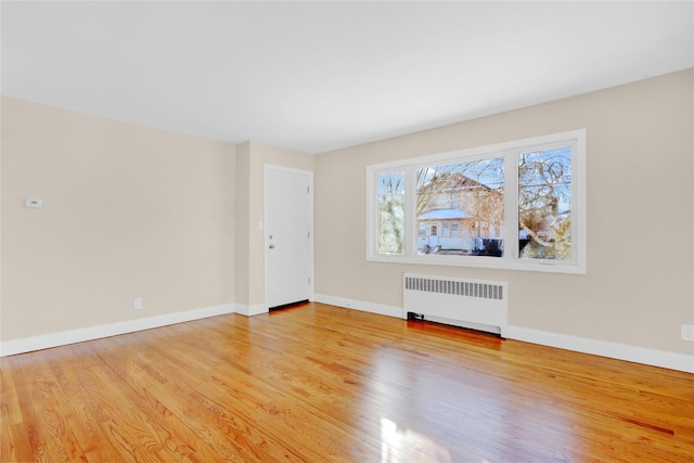 unfurnished living room featuring light hardwood / wood-style flooring and radiator