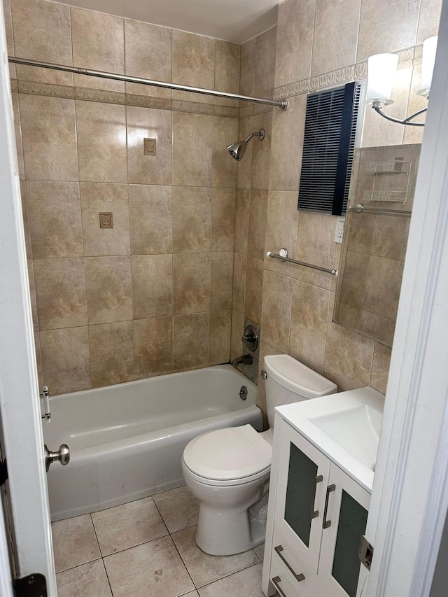 full bathroom featuring vanity, tile patterned floors, tile walls, and tiled shower / bath combo