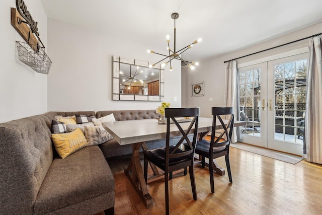 dining room with breakfast area, french doors, and light wood-type flooring