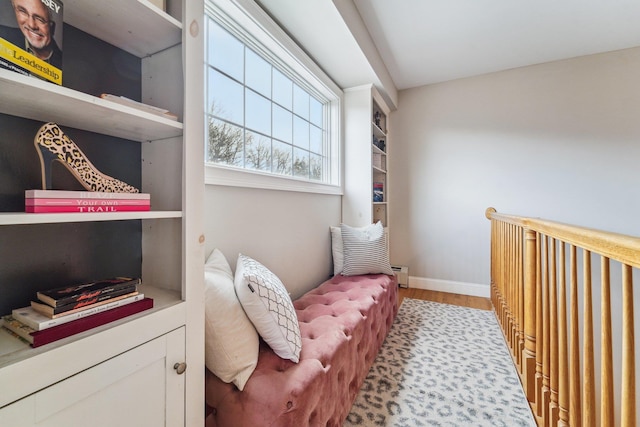 living area featuring baseboard heating and light hardwood / wood-style flooring