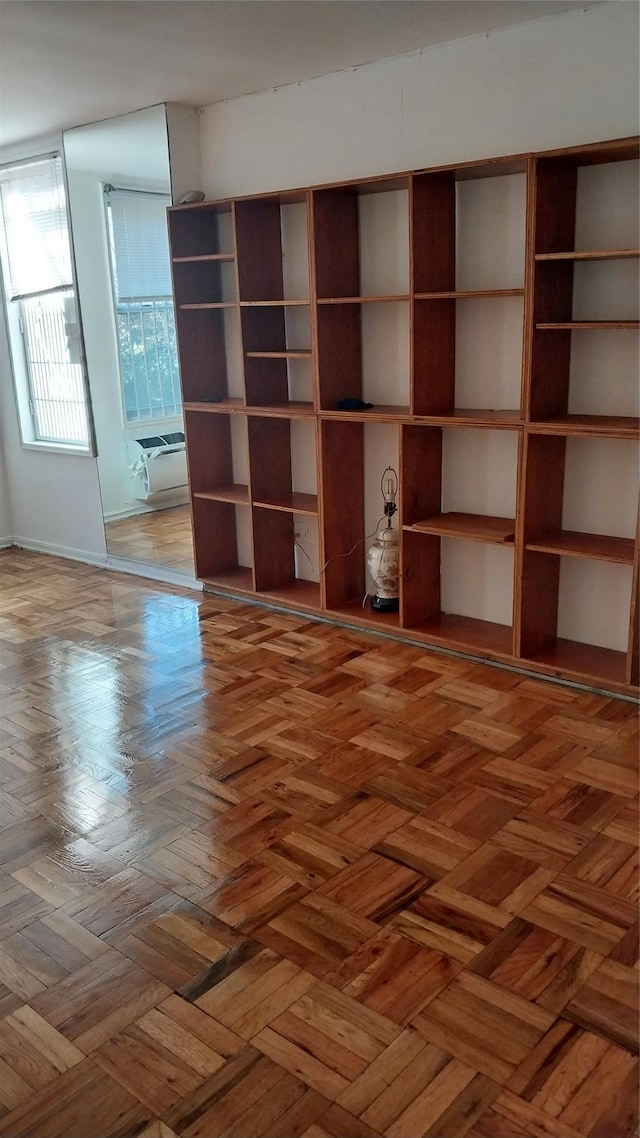 unfurnished living room with parquet flooring