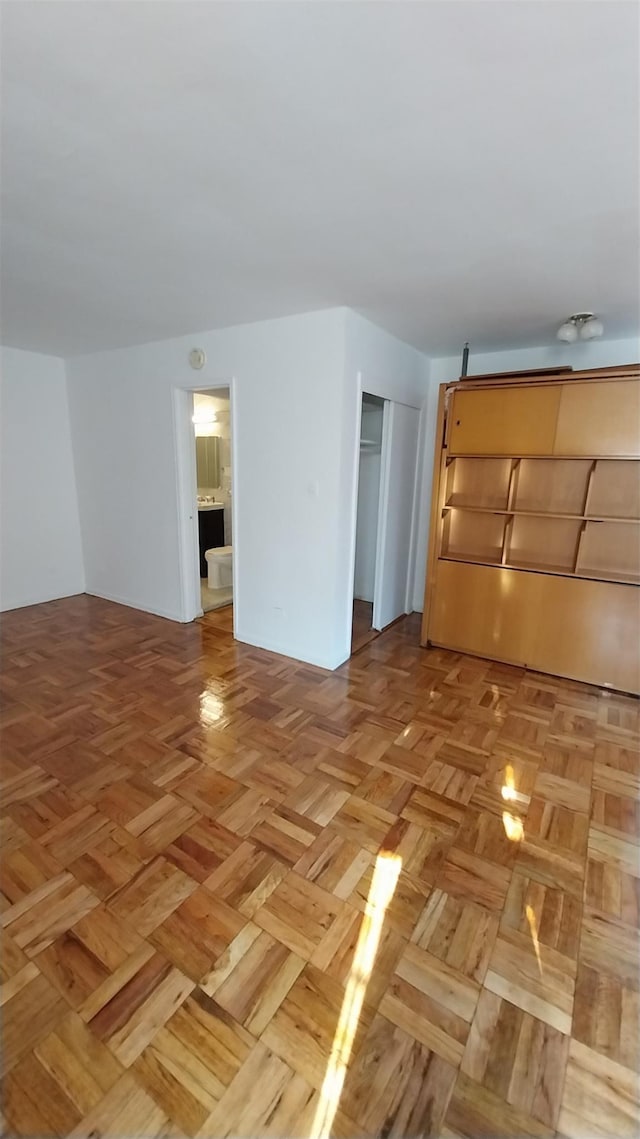 unfurnished living room featuring light parquet flooring