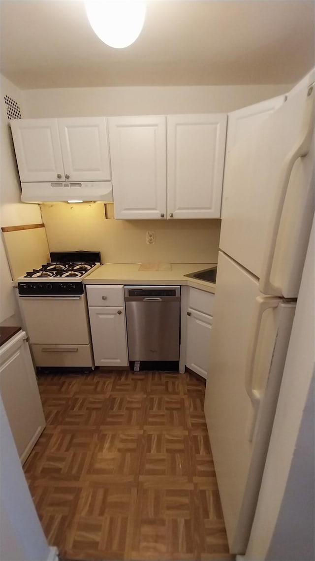 kitchen with dark parquet floors, white cabinetry, and white appliances