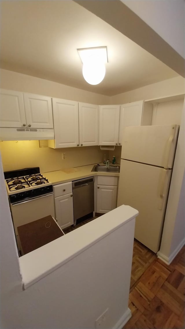 kitchen with white cabinetry, dark parquet floors, white appliances, and sink