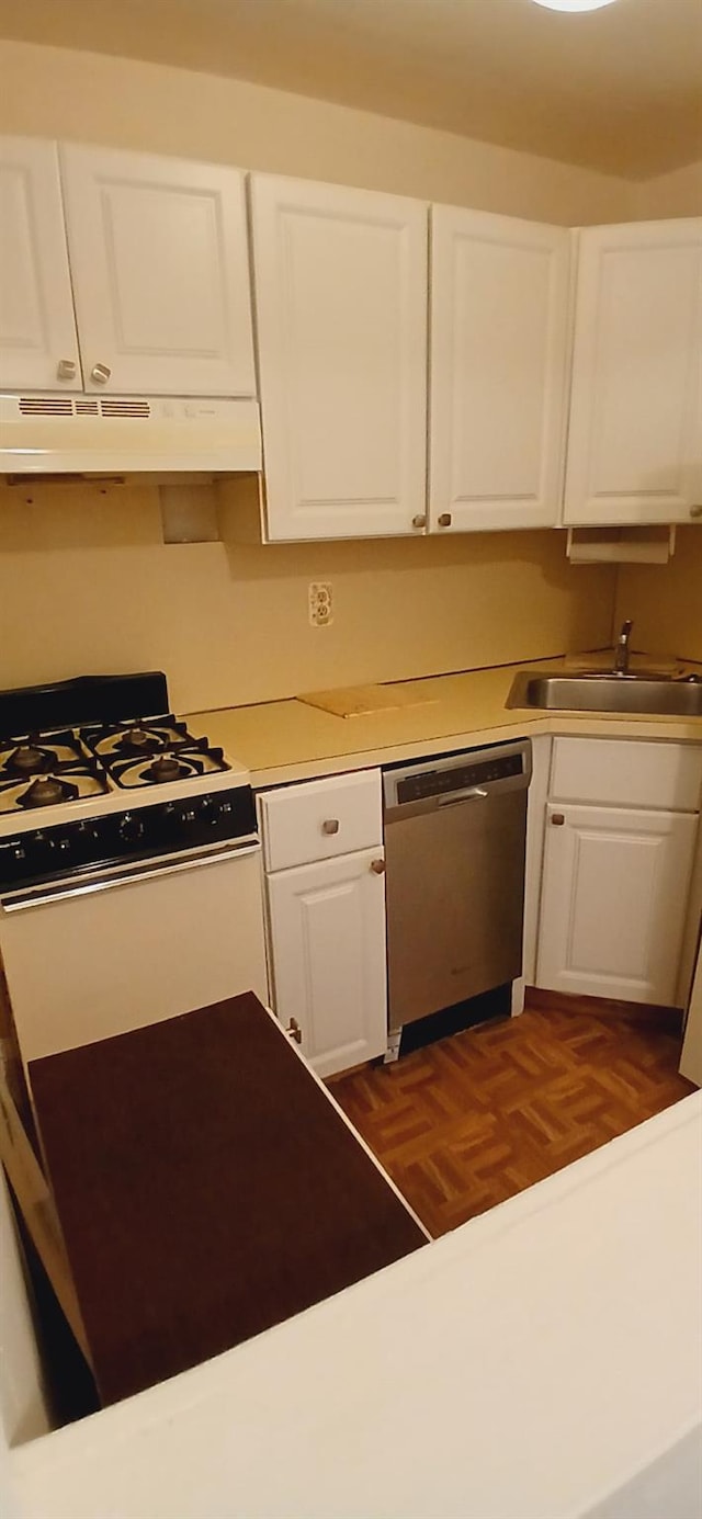 kitchen featuring a sink, under cabinet range hood, white cabinets, and dishwasher