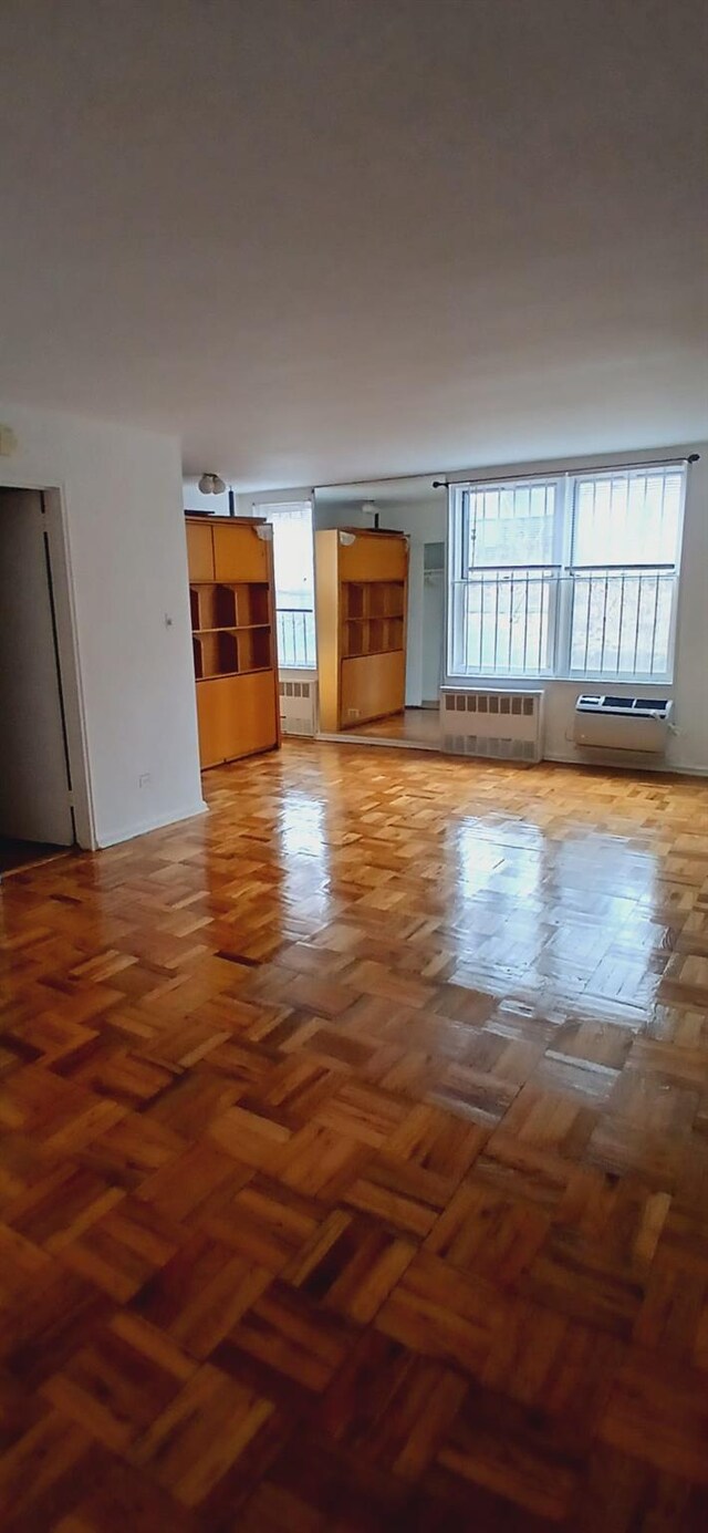 unfurnished living room featuring radiator heating unit