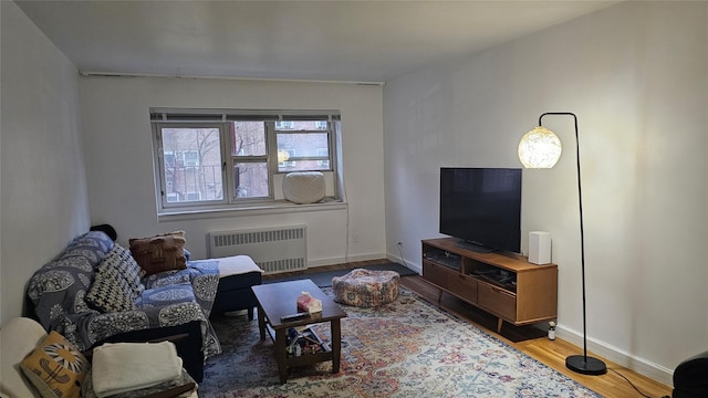 living room with radiator and hardwood / wood-style floors