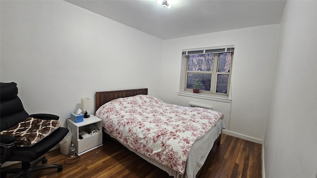 bedroom featuring dark hardwood / wood-style flooring