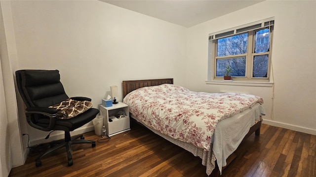 bedroom with dark wood-type flooring