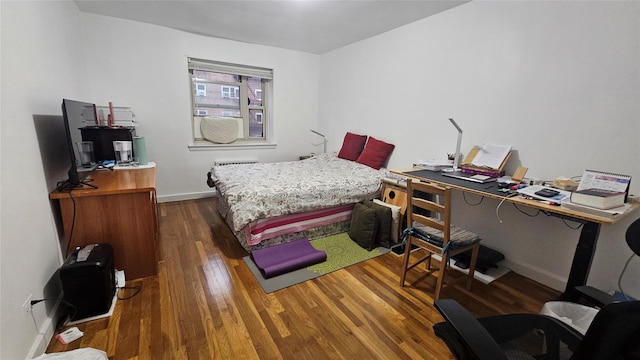 bedroom with dark hardwood / wood-style floors