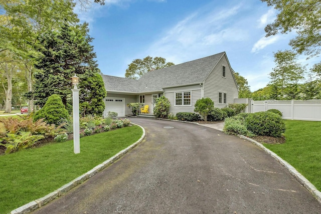 view of front facade with a garage and a front lawn