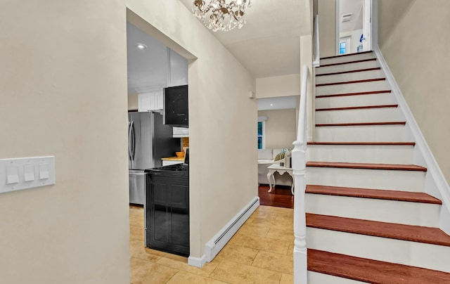 stairs with tile patterned flooring, a baseboard radiator, and a notable chandelier