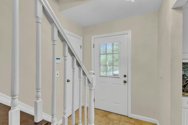 entryway with light tile patterned flooring