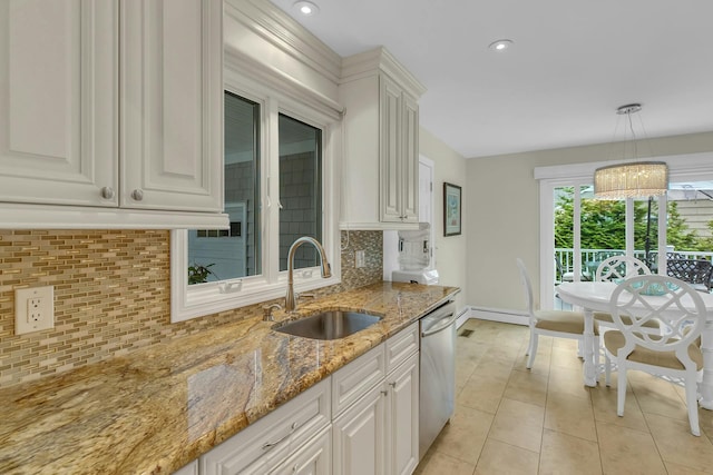 kitchen with decorative backsplash, sink, and white cabinets