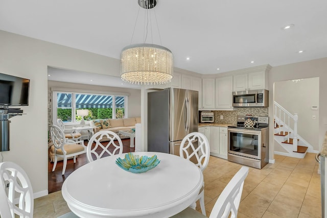 dining area featuring a notable chandelier and light tile patterned floors