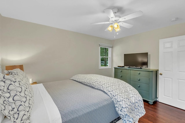 bedroom with ceiling fan and dark wood-type flooring