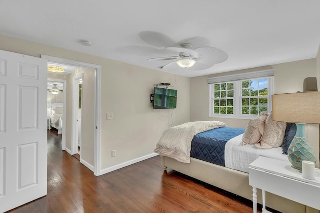 bedroom with dark hardwood / wood-style floors and ceiling fan