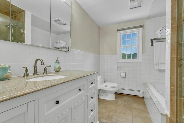 full bathroom featuring tile patterned flooring, vanity, baseboard heating, and tile walls