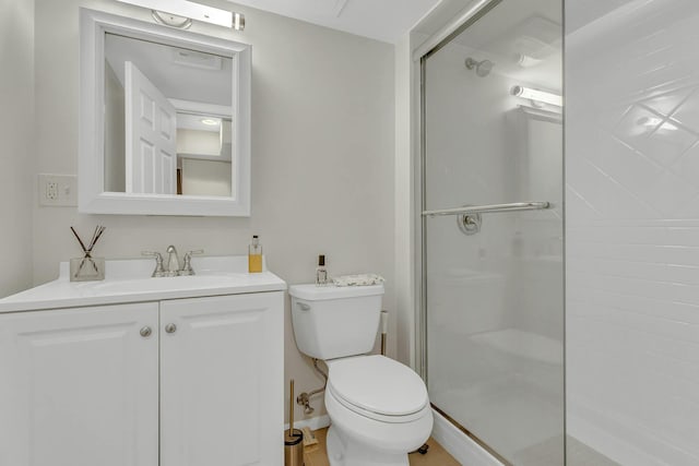 bathroom with vanity, toilet, and walk in shower