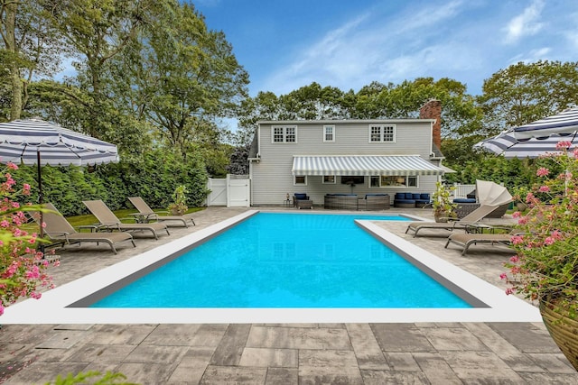 back of house featuring a patio area and outdoor lounge area