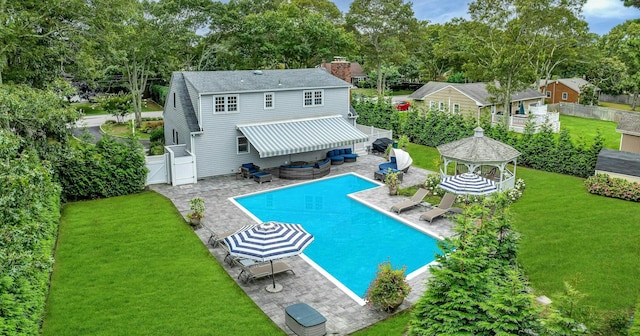 back of property featuring a gazebo, a patio area, an outdoor living space, and a lawn