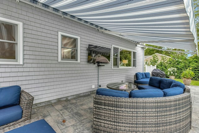 view of patio with grilling area and an outdoor hangout area