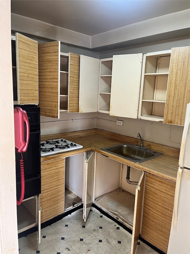 kitchen featuring white appliances and sink