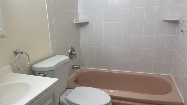 full bathroom featuring vanity, toilet, and tiled shower / bath